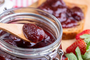 Bowl of strawberry jam isolated on white background from top view