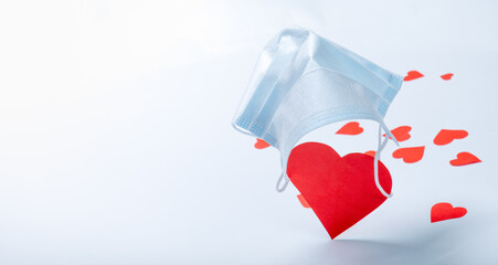 Red heart on parachute from medical mask.Valentine's day and coronavirus concept. Copy space. Creative ideas for Valentine's Day.