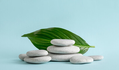 Natural smooth sea zen stones stacked as a natural pedestal for products background. Blank room for copy space.