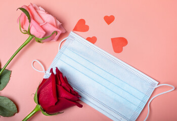 Roses on a pink background and a medical mask. New normal concept for Valentine's Day.