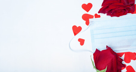 Red roses and medical mask and hearts on a white background. Valentine's day concept for coronavirus. Place for your text.