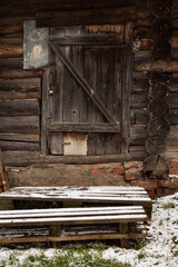 Fototapeta na wymiar Door from planks in wooden building of logs in the countryside