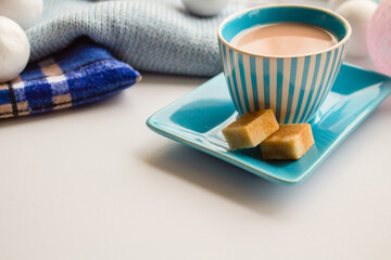 Coffee in a blue striped set and cubes of cane sugar in the New Year scenery