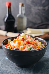 Frozen vegetables in bowl on dark background