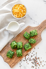 Frozen vegetables on wooden board