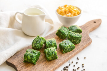 Frozen vegetables on wooden board