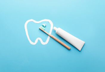 Toothbrush and paste on color background