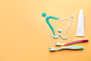 Composition with toothbrushes and paste on color background
