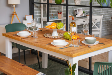 Table setting with fruits and wine in dining room