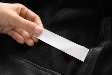 Hand and blank label on clothes
