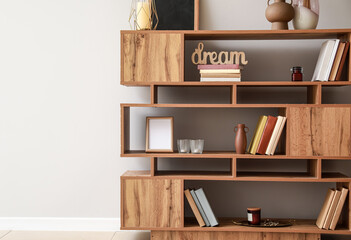 Shelving unit with books and decor in interior of room © Pixel-Shot