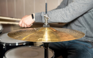 Close up of hands of drummer with sticks and metal plate or cymbal © valiantsin