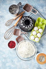 Baking ingredients and utensils, flour, eggs, baking dish on light background