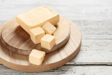 Chopping boards with fresh butter on wooden background