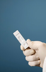 Doctor holding a test kit for viral disease tests with the COVID-19 SARS-CoV-2 laboratory card kit...