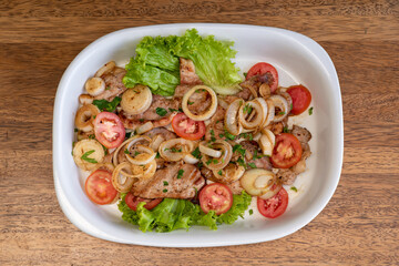 Pork meat grilled with fresh salad