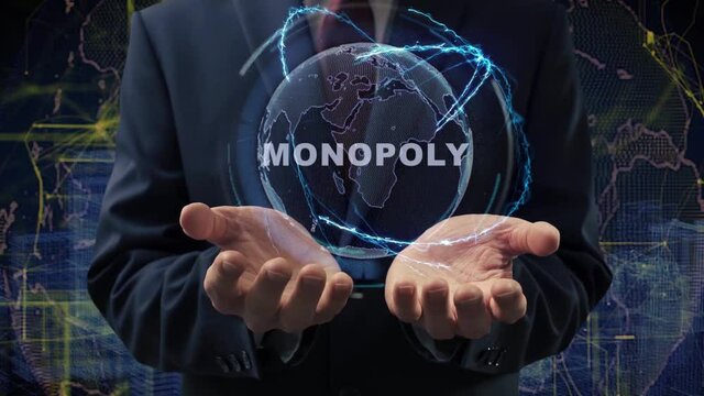 Male hands activate a conceptual holographic text Monopoly. Businessman in a suit with a hologram of planet Earth on a background of a futuristic wireframe city