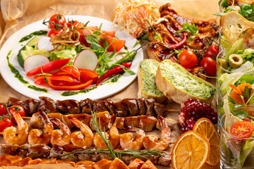 selection of different snacks. Kebabs, cheese, toast, bruschetta, salads, seafood and meat skeawers and bbq ribs. The view from the top. Catering