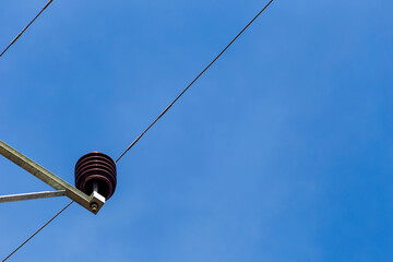 Electrical pole and line with sky.