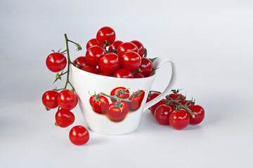 Cherry Tomatoes in a large white Cup. Isolated On White Background