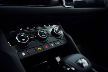 Knobs and buttons. Close up focused view of brand new modern black automobile