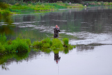 Fototapeta na wymiar A man near the water. Fishing on the river