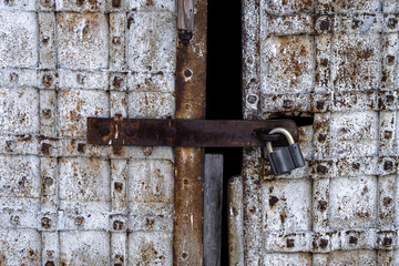 Old rusty metal lock and keyhole on a metal vintage rusty door