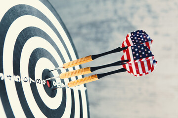 dart arrow hitting in the target center of dartboard.