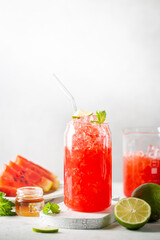 Refreshing cold summer watermelon drink in glasses with slices of watermelon and lime