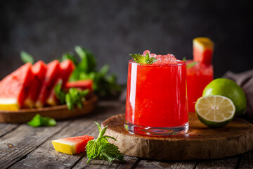 Refreshing cold summer watermelon drink in glasses with slices of watermelon and lime