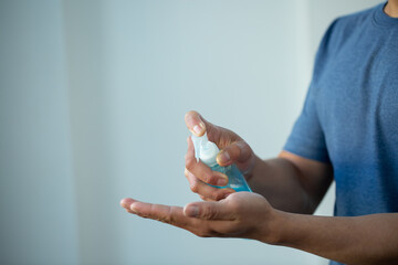 Man washing hands with alcohol gel or antibacterial soap sanitizer after using a public restroom.Hygiene concept. prevent the spread of germs and bacteria and avoid infections corona virus
