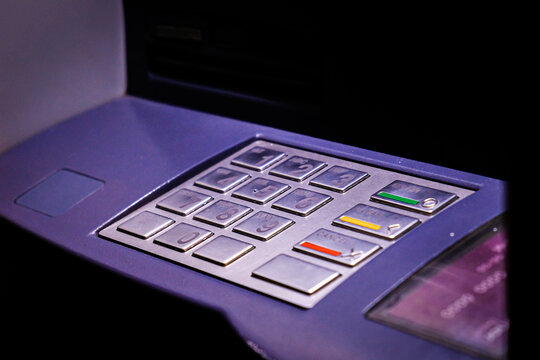 ATM Bank cash machine in the night, keyboard close-up. Selective focus