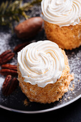 2 small and sweet tartlets with white cream on top and powder censer on a black table