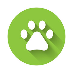 White Paw print icon isolated with long shadow. Dog or cat paw print. Animal track. Green circle button. Vector.