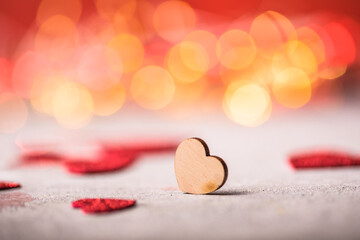 Valentines Day background. Wooden heart on the red background.