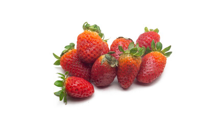 Close up view a group of fresh red strawberries with leaves on isolated white background.