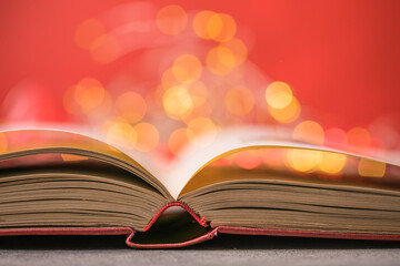 Book with lights on red background. Romantic Valentine  concept