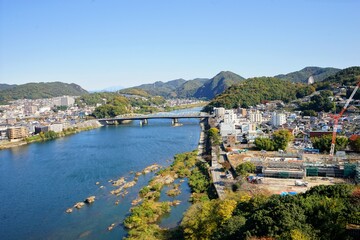 Fototapeta premium Landscape of Kiso River and Inuyama City from Inuyama Castle in Inuyama City, Aichi, Japan - 犬山城からの木曽川