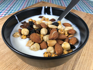 Mixed nuts above the yogurt in a bowl