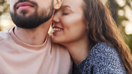 Closeness of the people. Cheerful lovely young couple having a rest outdoors together