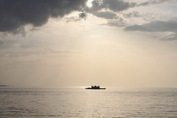Naklejka premium Boat on Hellespont under the evening lights