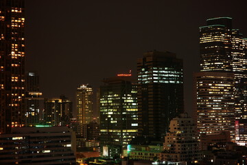 Night city scape building tower at business area, Silom Bangkok.
