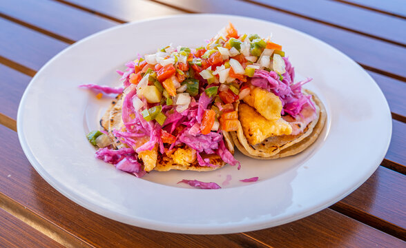 Red Snapper Fish Tacos On White Plate And Wood Table