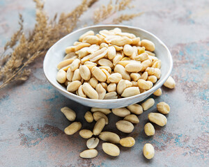 Peeled peanuts in a wooden bowl