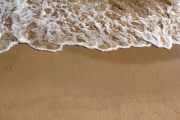 brown Sand beach and Wave foam.
