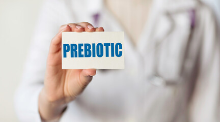 Doctor holding a card with text word PREBIOTIC, medical concept.