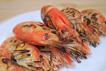 Closeup of Tasty Flaming Grilled River Prawns on a White Plate	