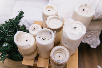 Large thick candles stand as the decor of the room. The burnt wicks of candles.
