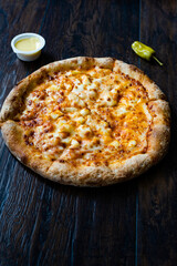 Pizza Quattro Formaggi Four Cheese Pizza on Wooden Surface.