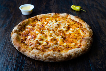 Pizza Quattro Formaggi Four Cheese Pizza on Wooden Surface.